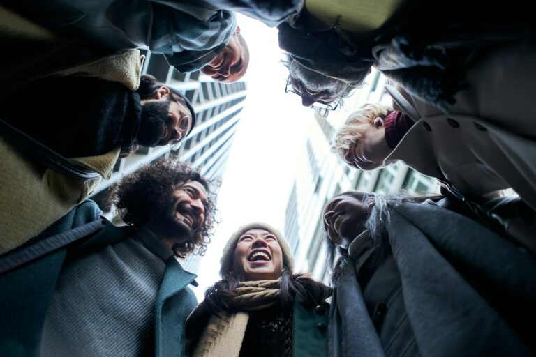 Low angle of a unity group of business people in circle.