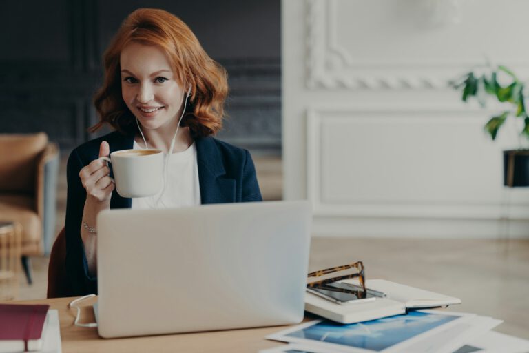 woman watches training webinar on laptop computer, browses information for project